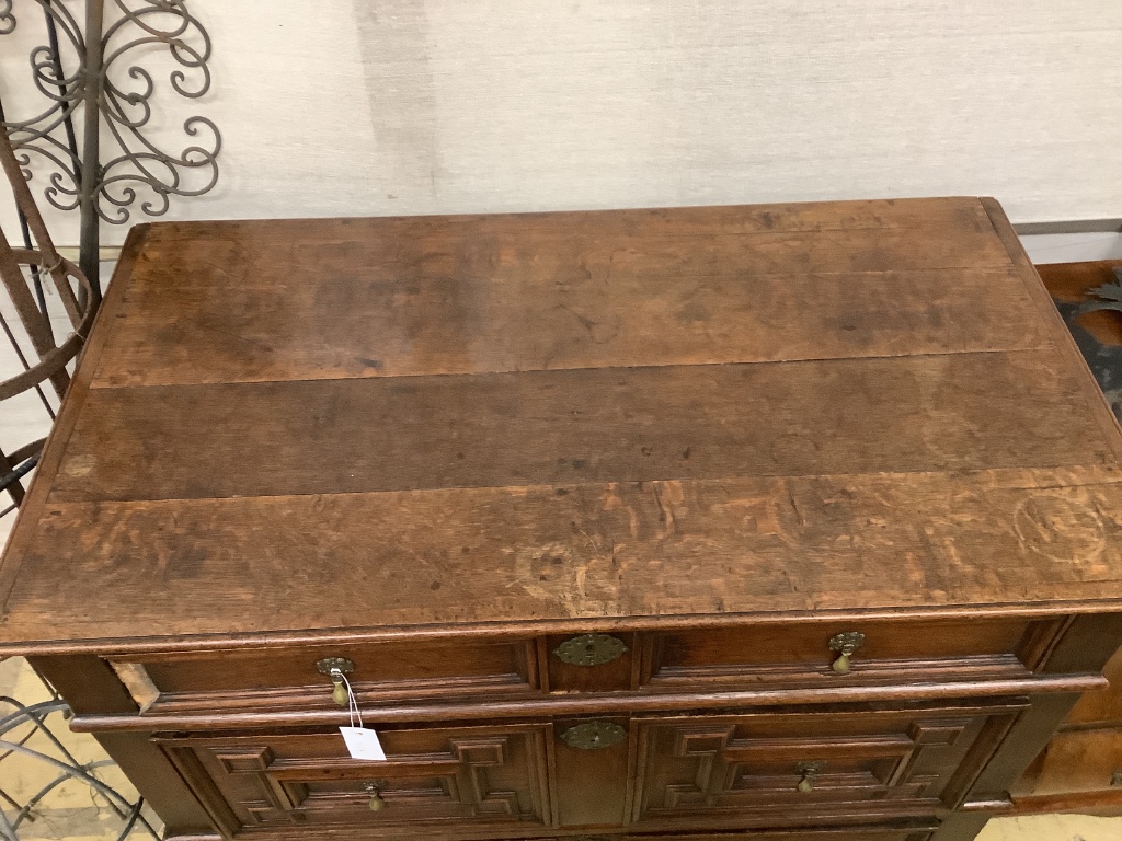 An 18th century oak geometric moulded two part chest, width 105cm, depth 58cm, height 100cm